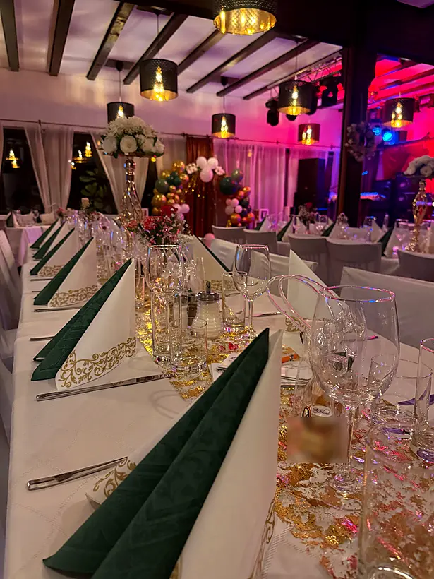 Lange Festtafel im Restaurant mit Partybeleuchtung